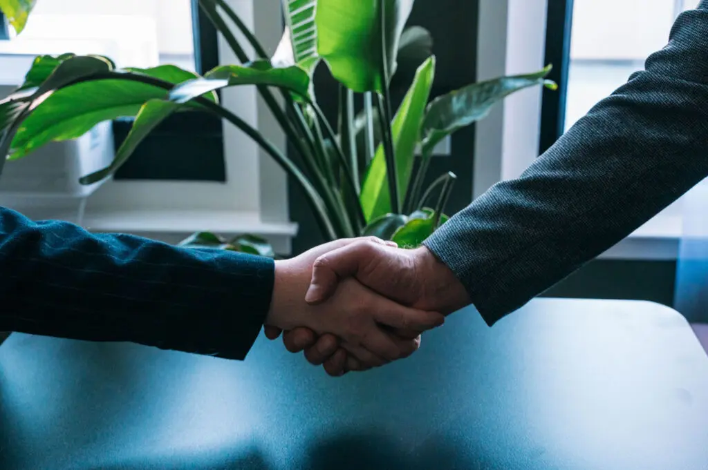 Alice shaking hands with a client